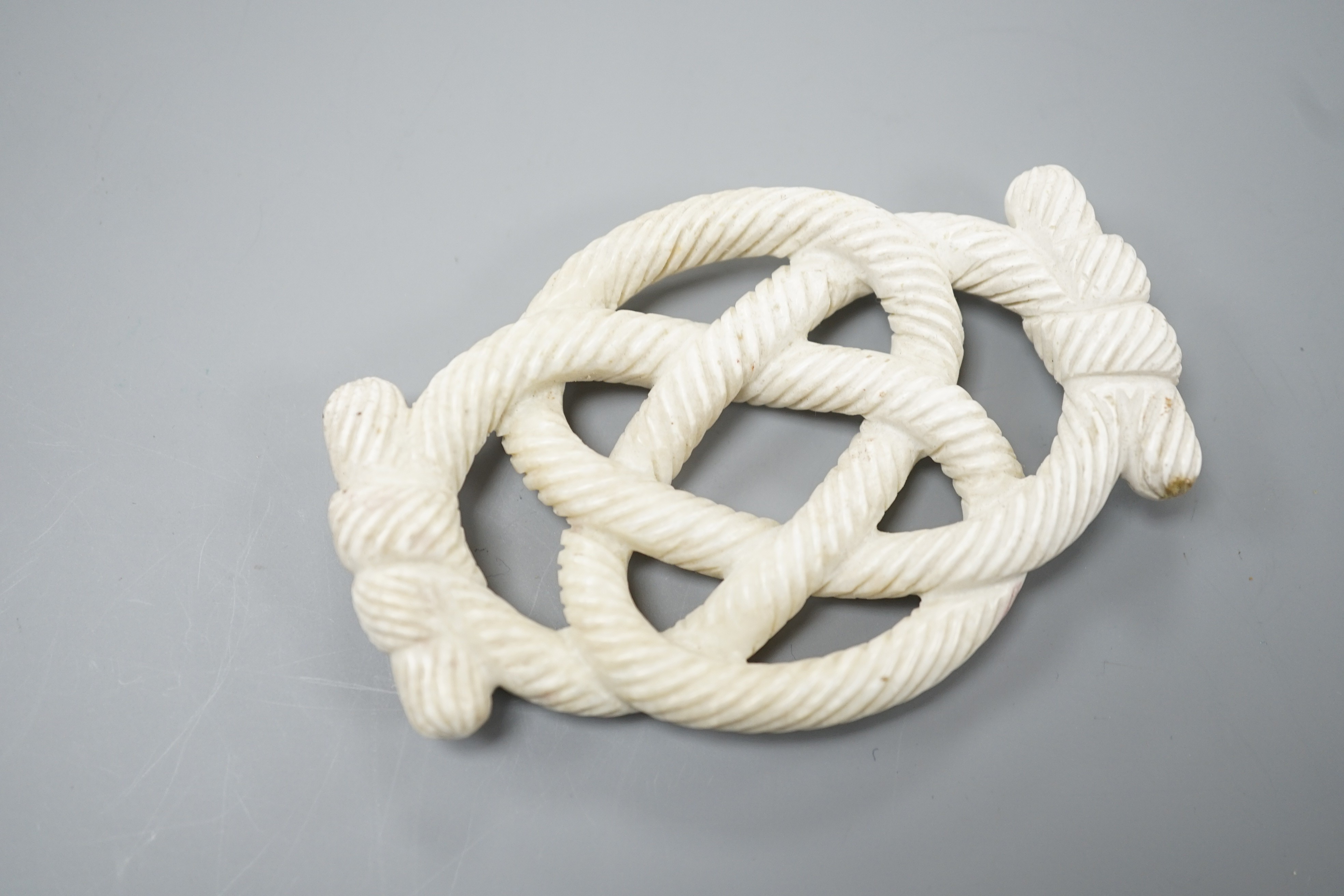 A Chinese hardstone eternal knot carving, 19th century, possibly burnt jade, 8.4cm